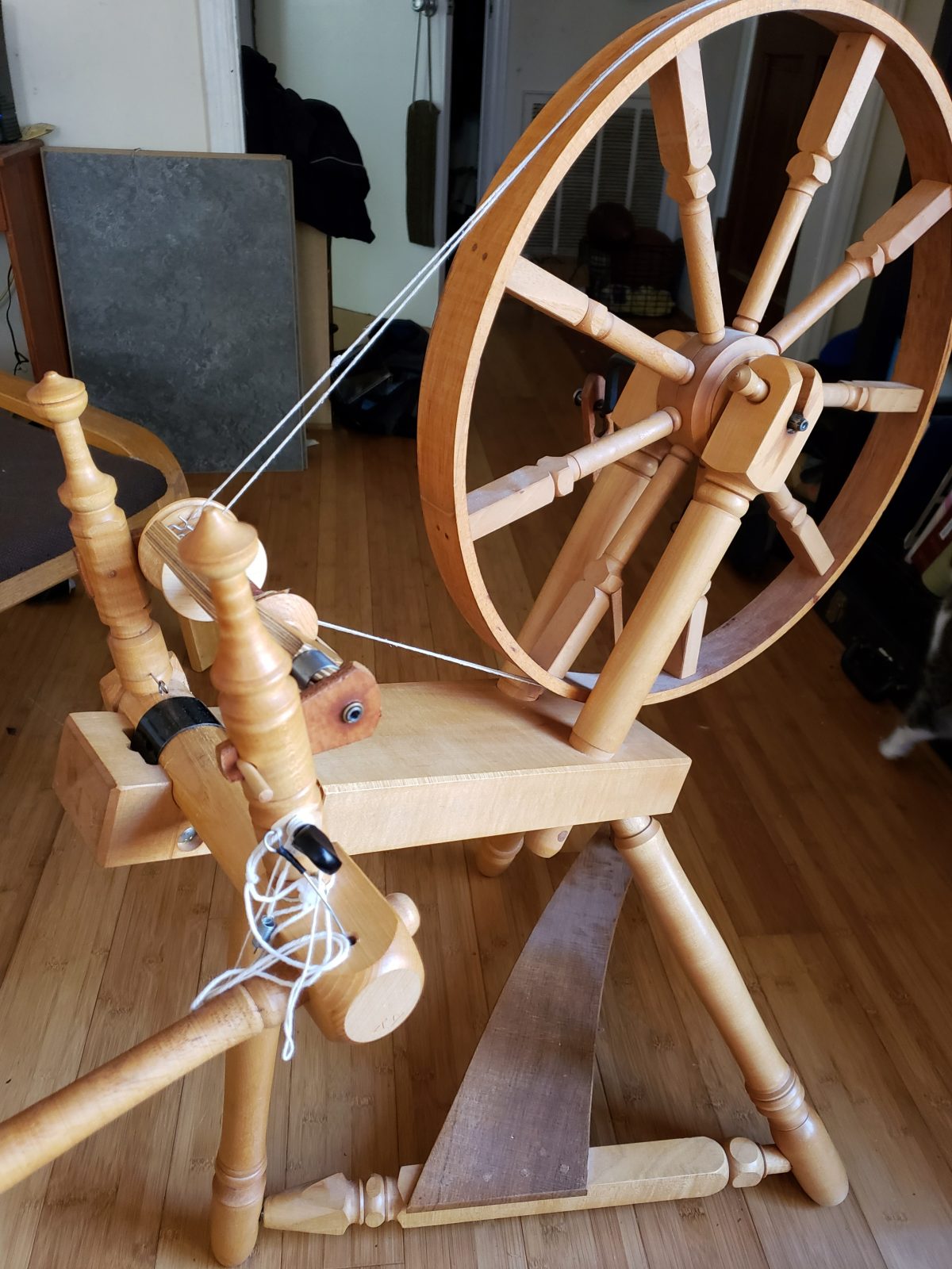 An Alden Amos flat-rim 'suitcase' spinning wheel set up with tilt-tension double drive.